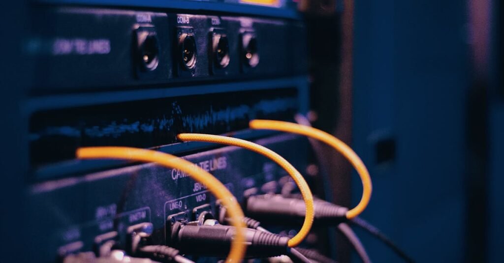 Close-up of network cables and ports in a server rack, showcasing connectivity.